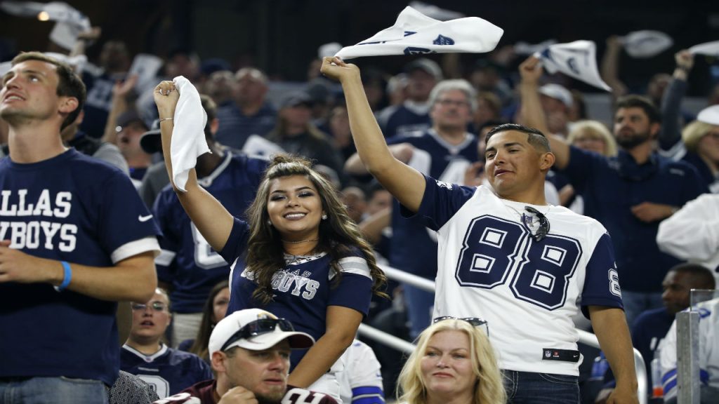 Dallas Cowboys fans cheering, waving white towels