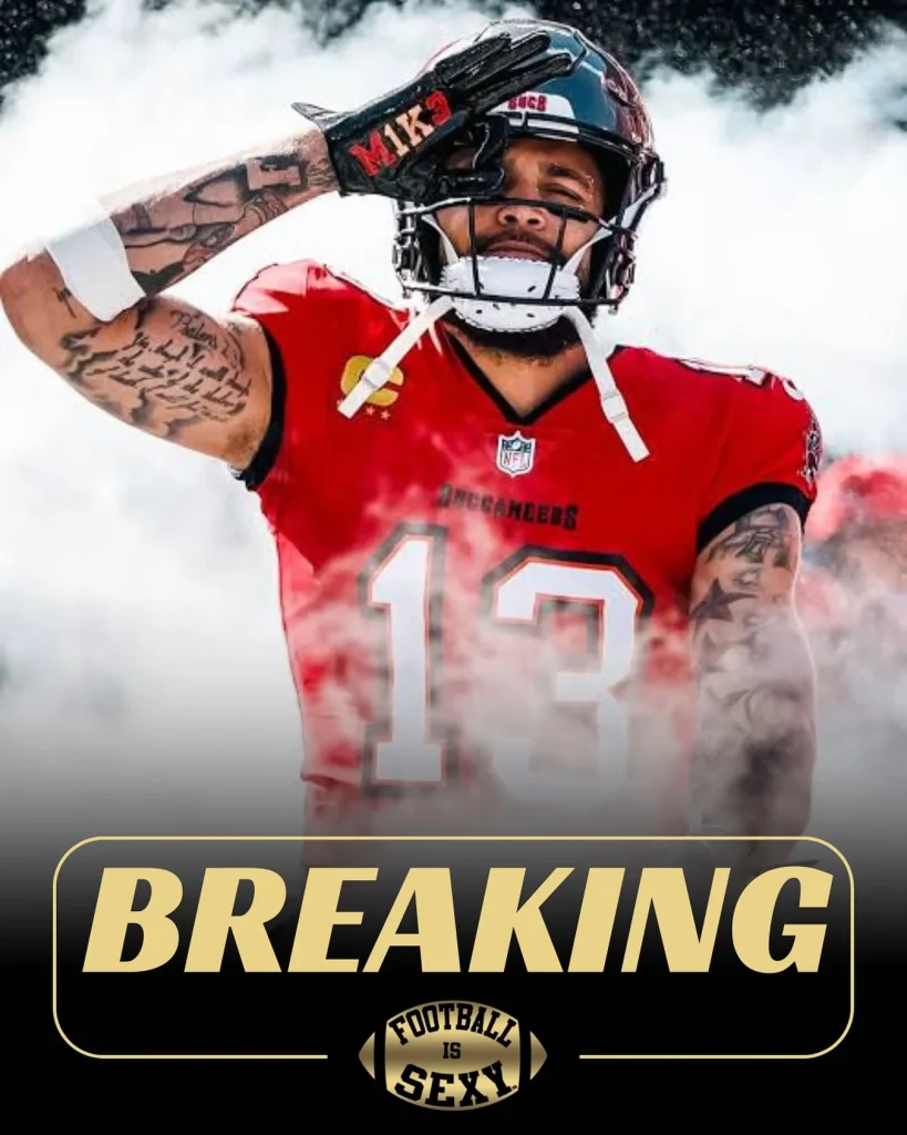 Football player in red jersey emerging from smoke