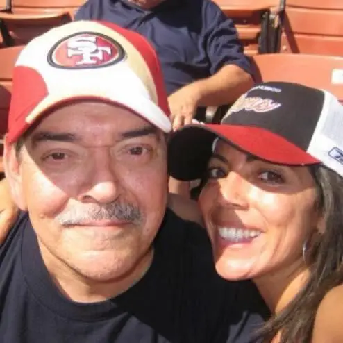 Monica Madrid and her dad together at a football game.